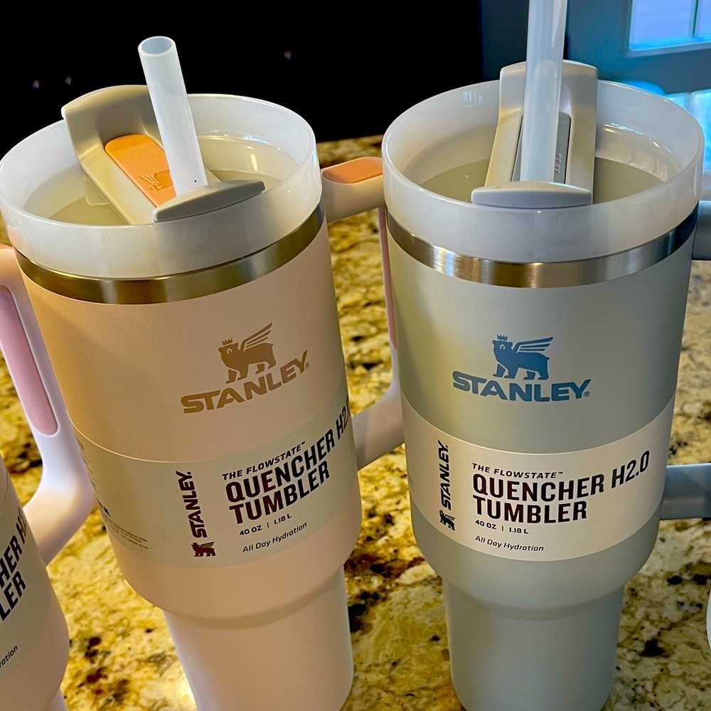 1 rose quartz and 1 fog Stanley tumbler